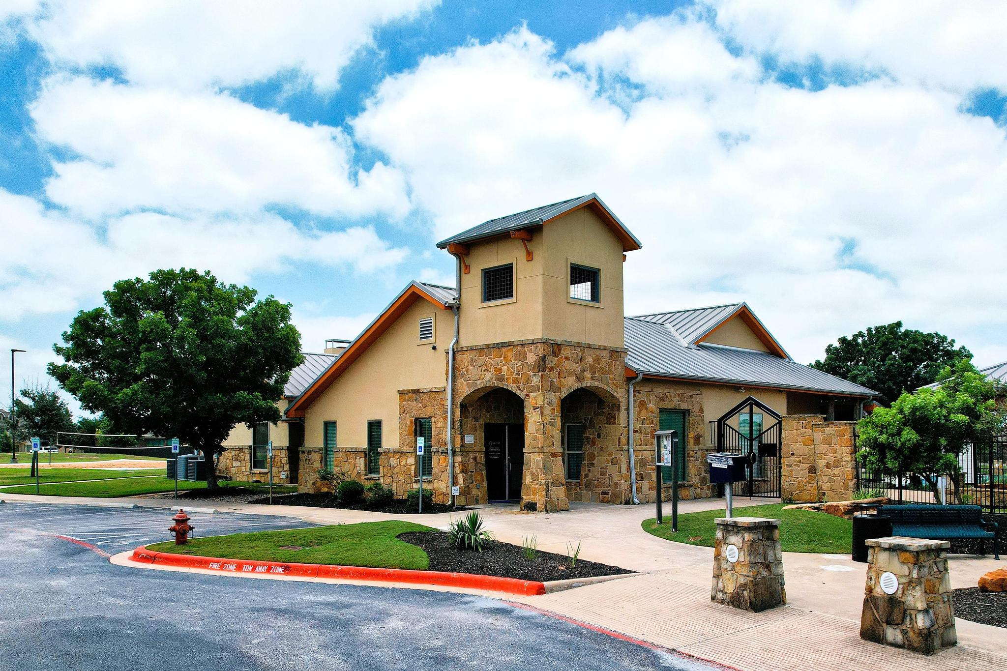 Exterior view of the Blackhawk Amenity Center with stone entry and metal roof.