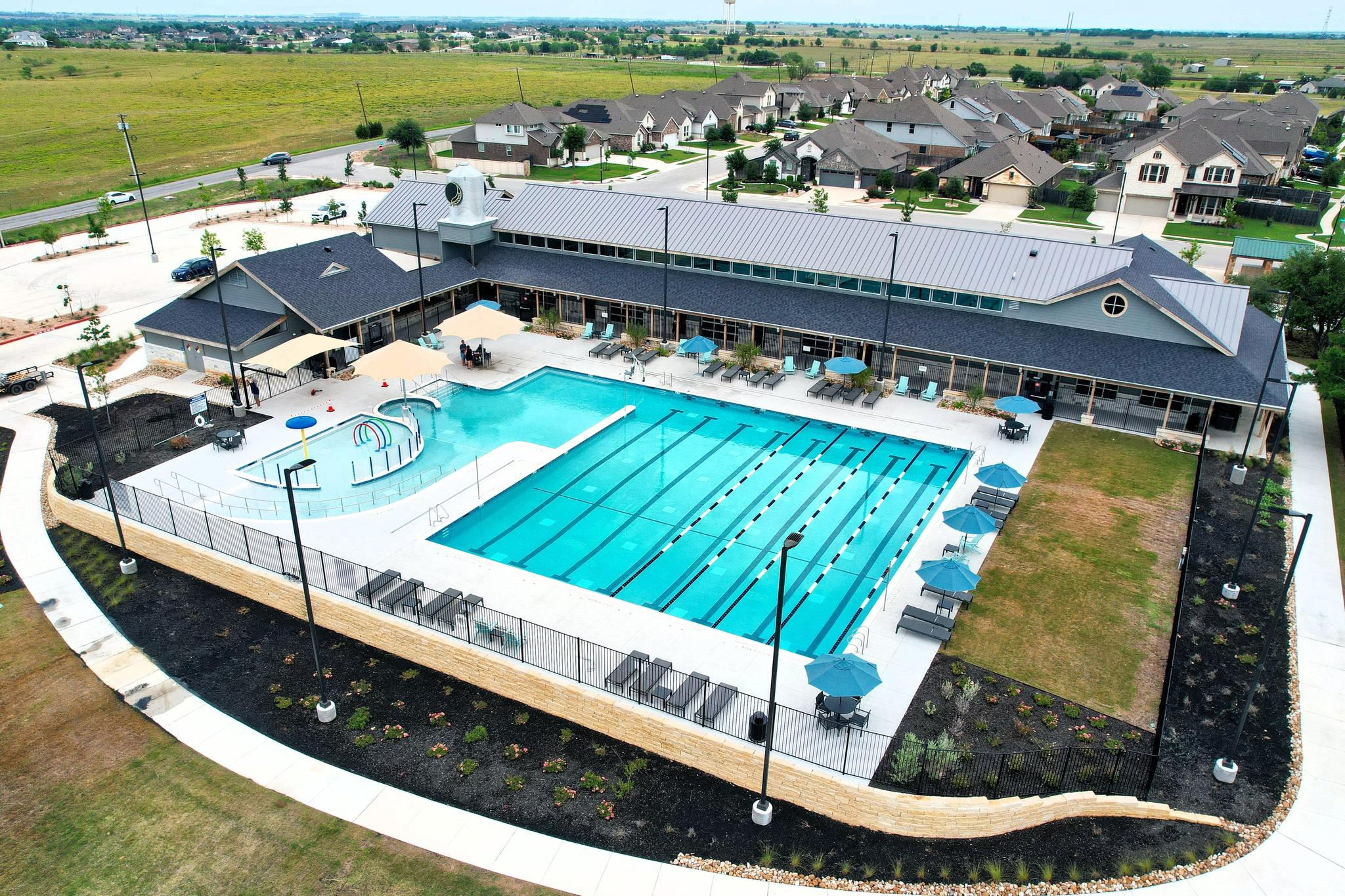 Aerial view of the Carries Ranch Recreation Center pool, pool deck, and recreation center building.
