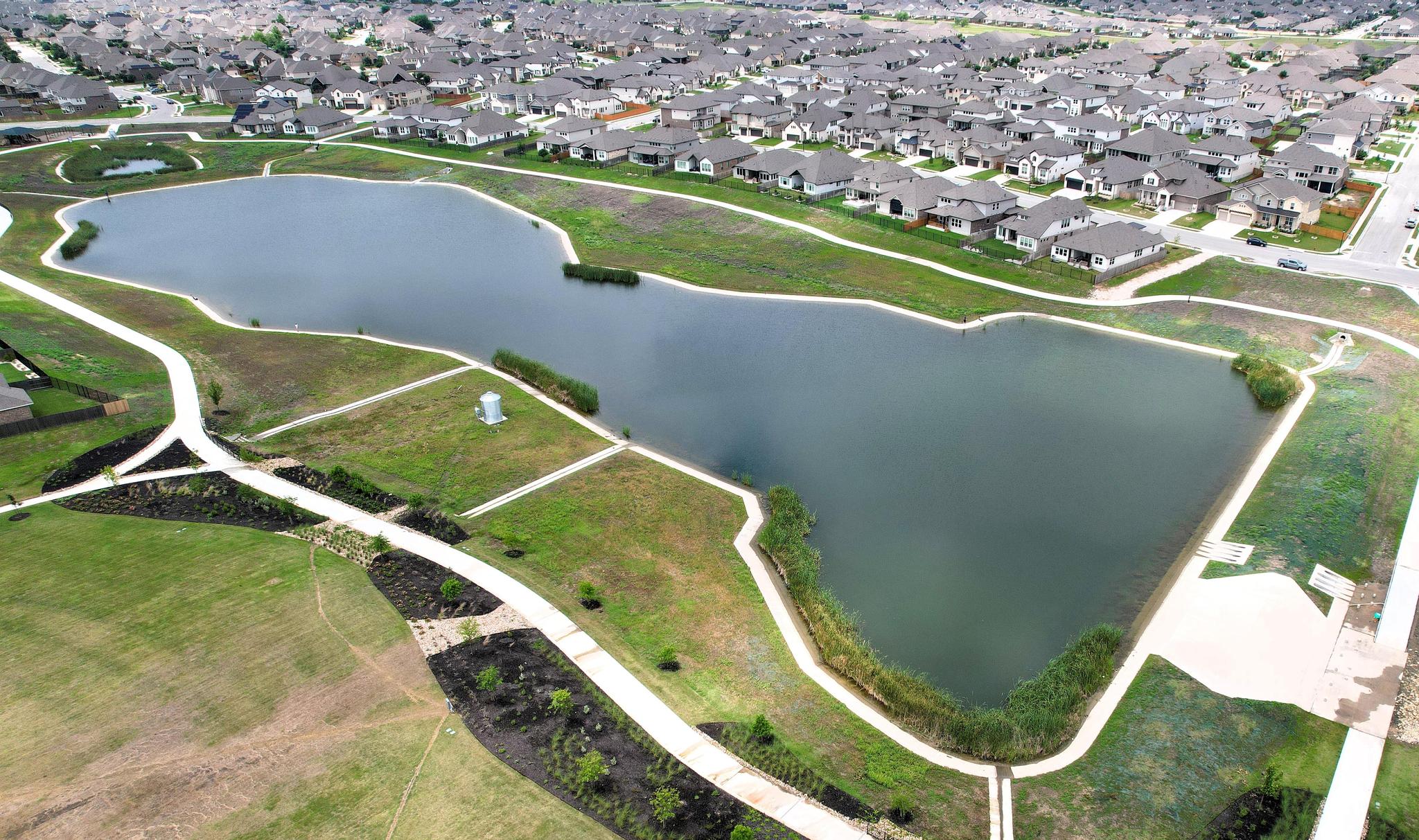 Aerial view of Blackhawk greenbelt trails around a community lake and nearby homes.